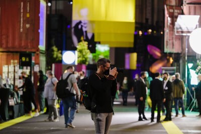 Photographer in a trade fair hall taking a picture