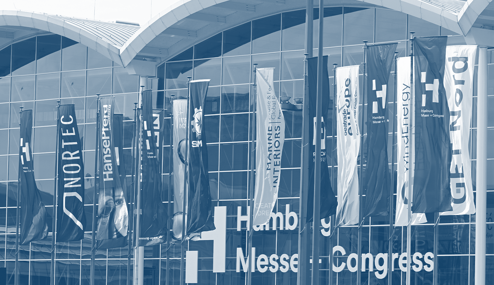 Flags of various trade fairs in front of the exhibition halls