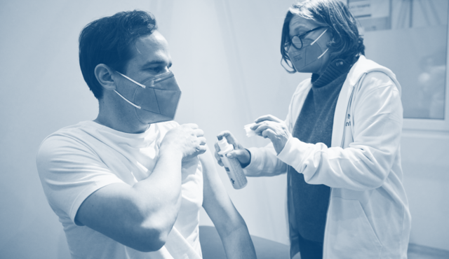 A doctor vaccinates a patient