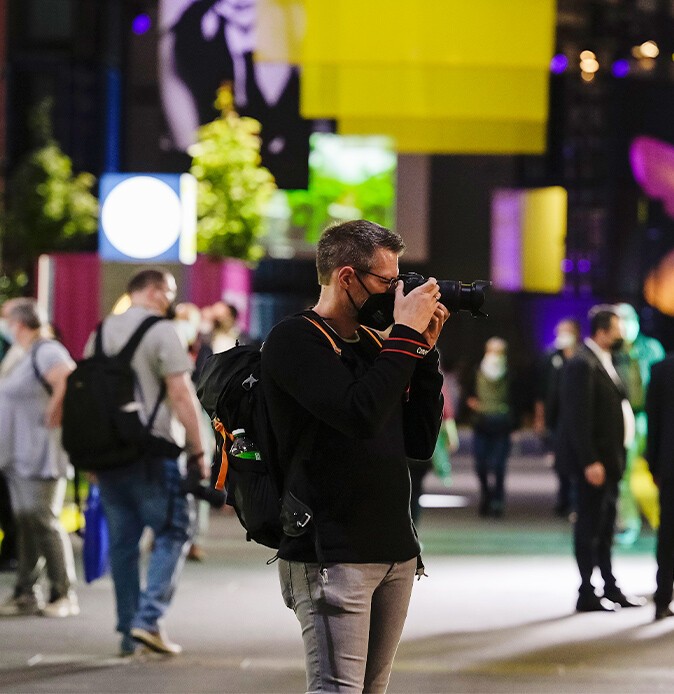 Photographer in a trade fair hall taking a picture