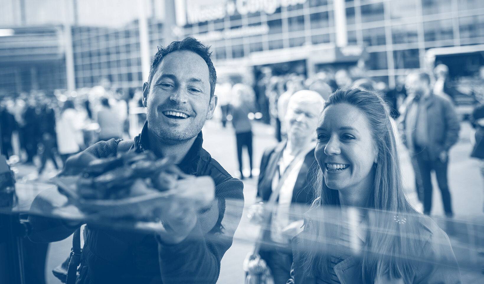 A man and woman being handed fresh food