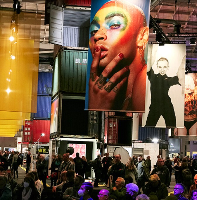 A large image showing a person wearing make-up, and a smaller image of a woman in the exhibition hall during PHOTOPIA 2022