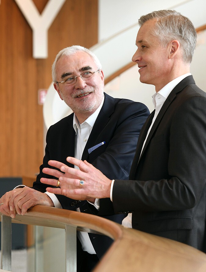A photo showing Bernd Aufderheide (President and CEO) and Uwe Fischer (CFO) in conversation.