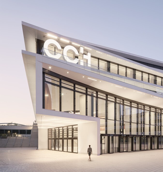 The CCH building with a person standing in front