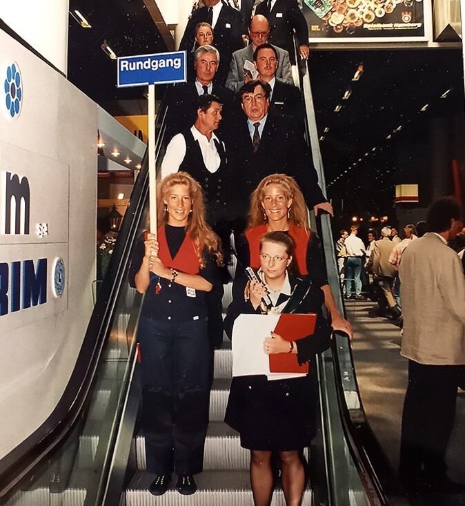 Trade fair visitors on an escalator while taking a tour of the premises