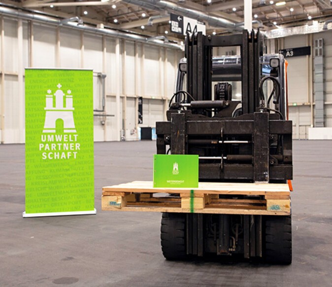 An electrically operated forklift in the HMC exhibition halls showing the logo of an environmental organization 