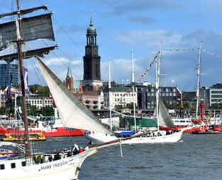 Several ships on the river Elbe, with Saint Michael's Church in the background