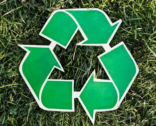 A recycling symbol on the lawn