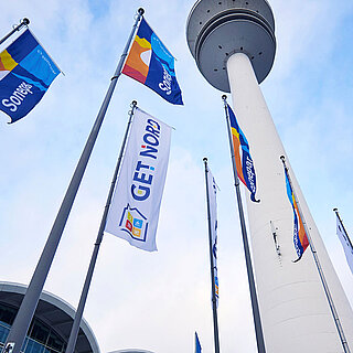 GET NORD - Flags and TV tower at the Central Entrance