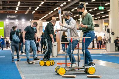 Visitors at the 'therapie Hamburg' fair try out physiotherapeutic equipment