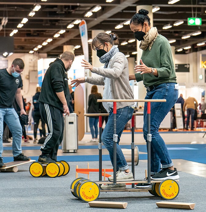 Visitors at the "therapie Hamburg" fair try out physiotherapy equipment