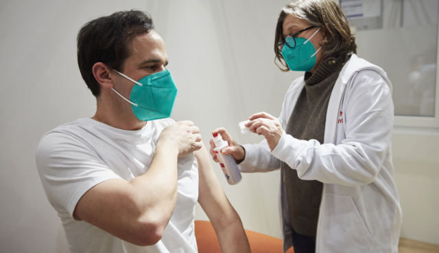 A doctor vaccinates a patient