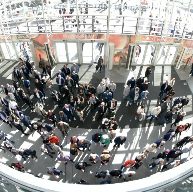 The main entrance of Hamburg Messe full of people as seen from above